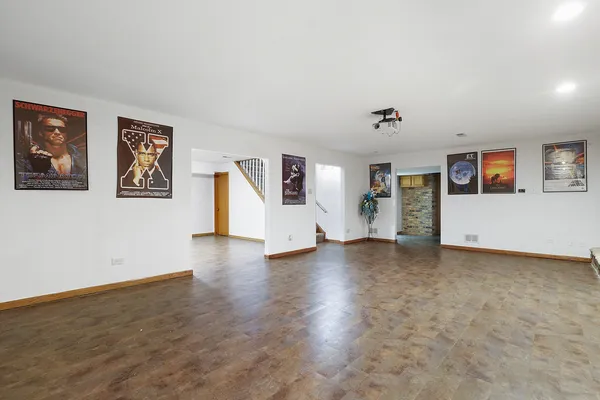 a view of a livingroom with wooden floor and white walls