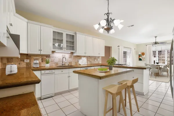 a kitchen with cabinets a sink and appliances