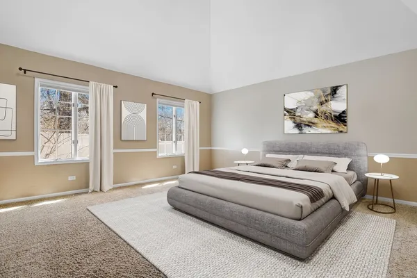 a spacious bedroom with a large bed and a window