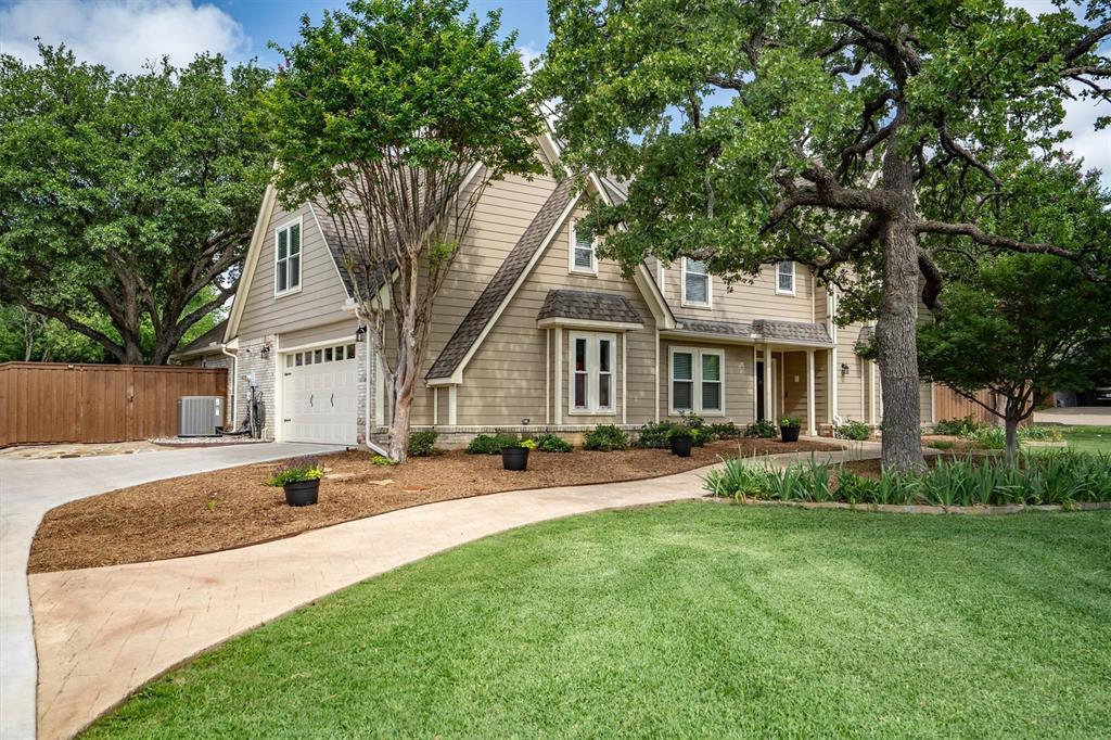 Classic curb appeal with lush lawn and mature trees; a beautiful first impression.