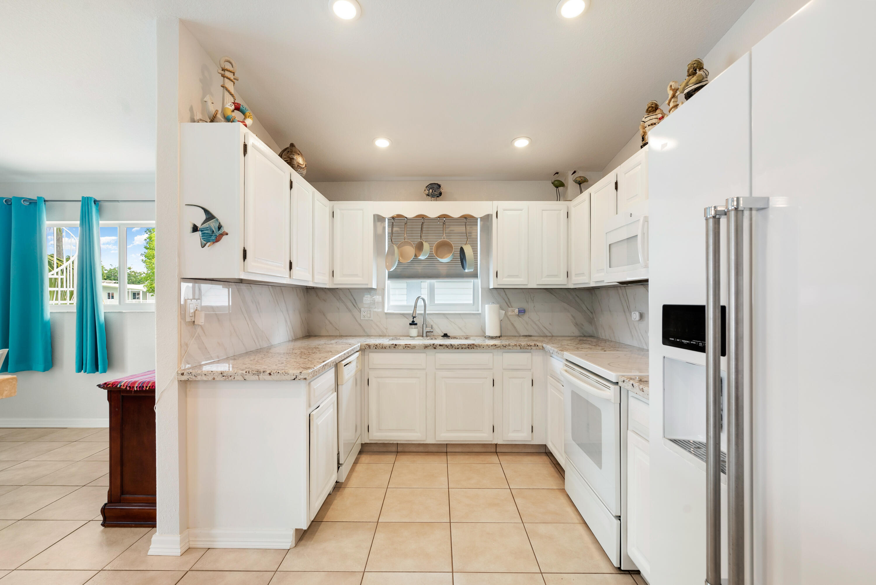 1210 Cactus Street Key Largo, FL 33037 - Photo 12 of 41 a kitchen with white cabinets appliances and a sink