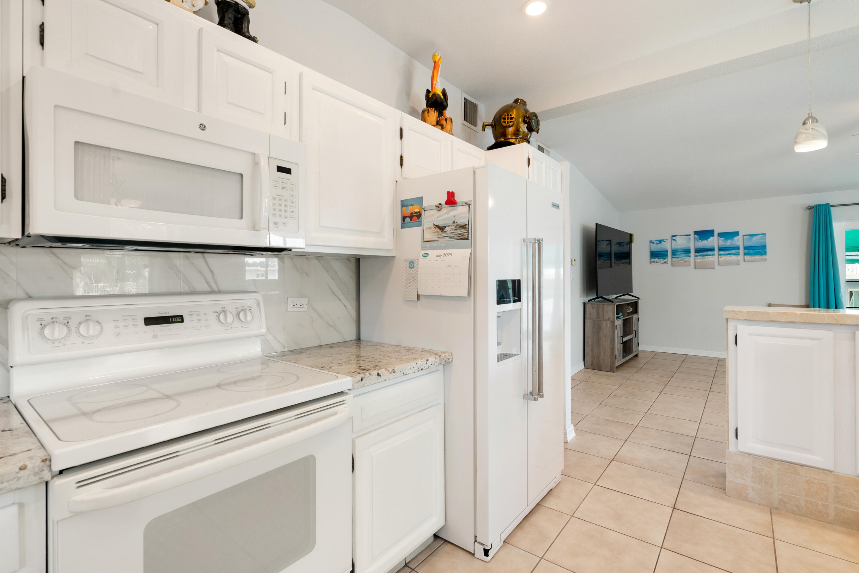 1210 Cactus Street Key Largo, FL 33037 - Photo 13 of 41 a kitchen with white cabinets and white appliances