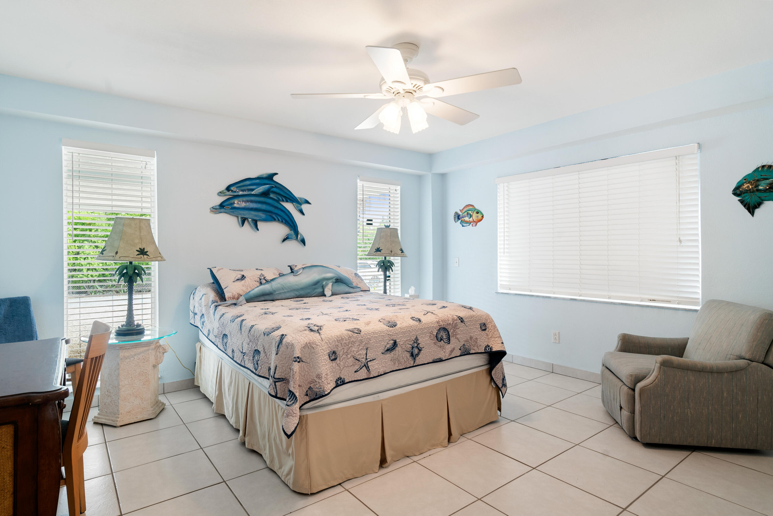 1210 Cactus Street Key Largo, FL 33037 - Photo 33 of 41 a bedroom with a bed and a chandelier
