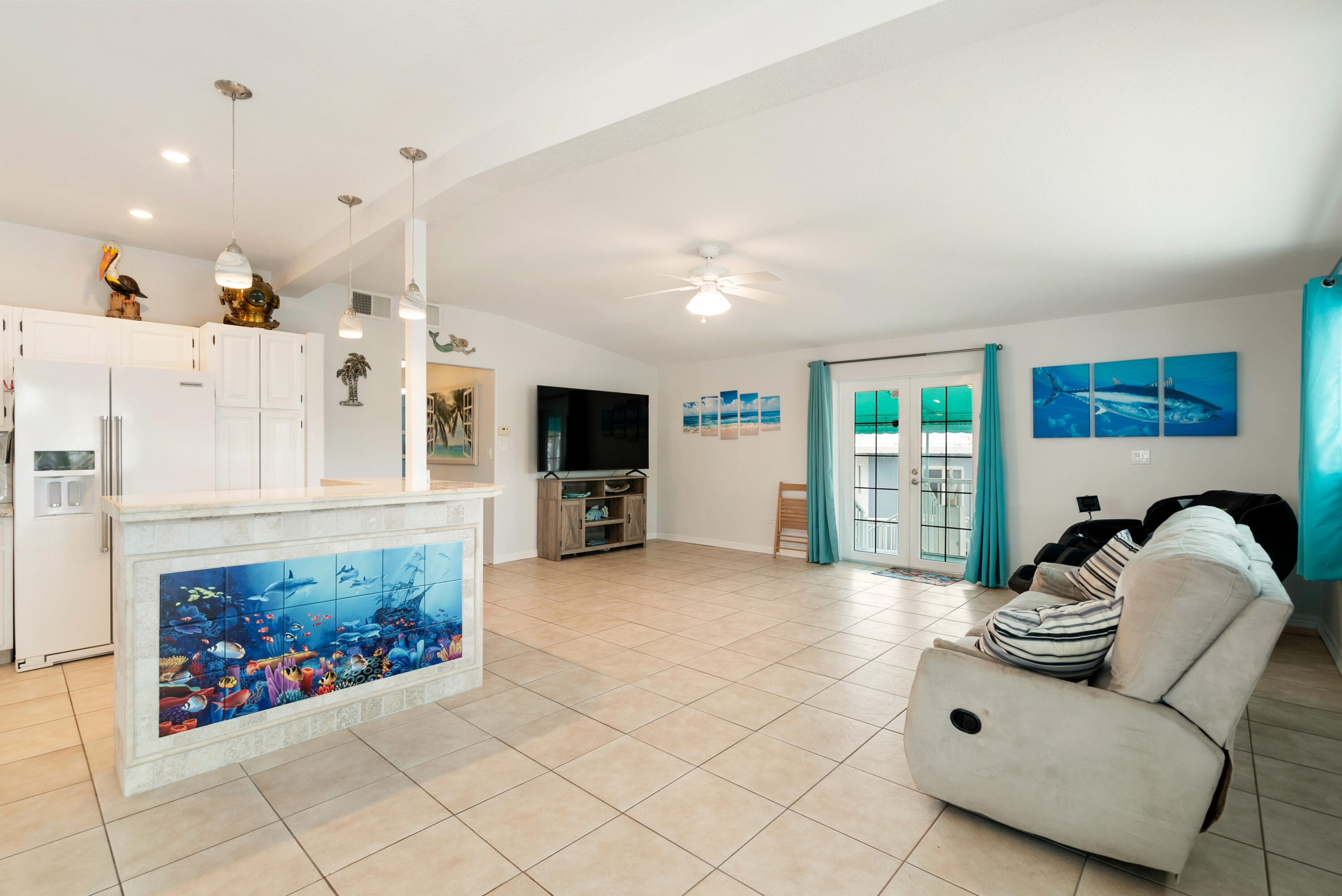 1210 Cactus Street Key Largo, FL 33037 - Photo 9 of 41 a living room with furniture a flat screen tv and a fireplace