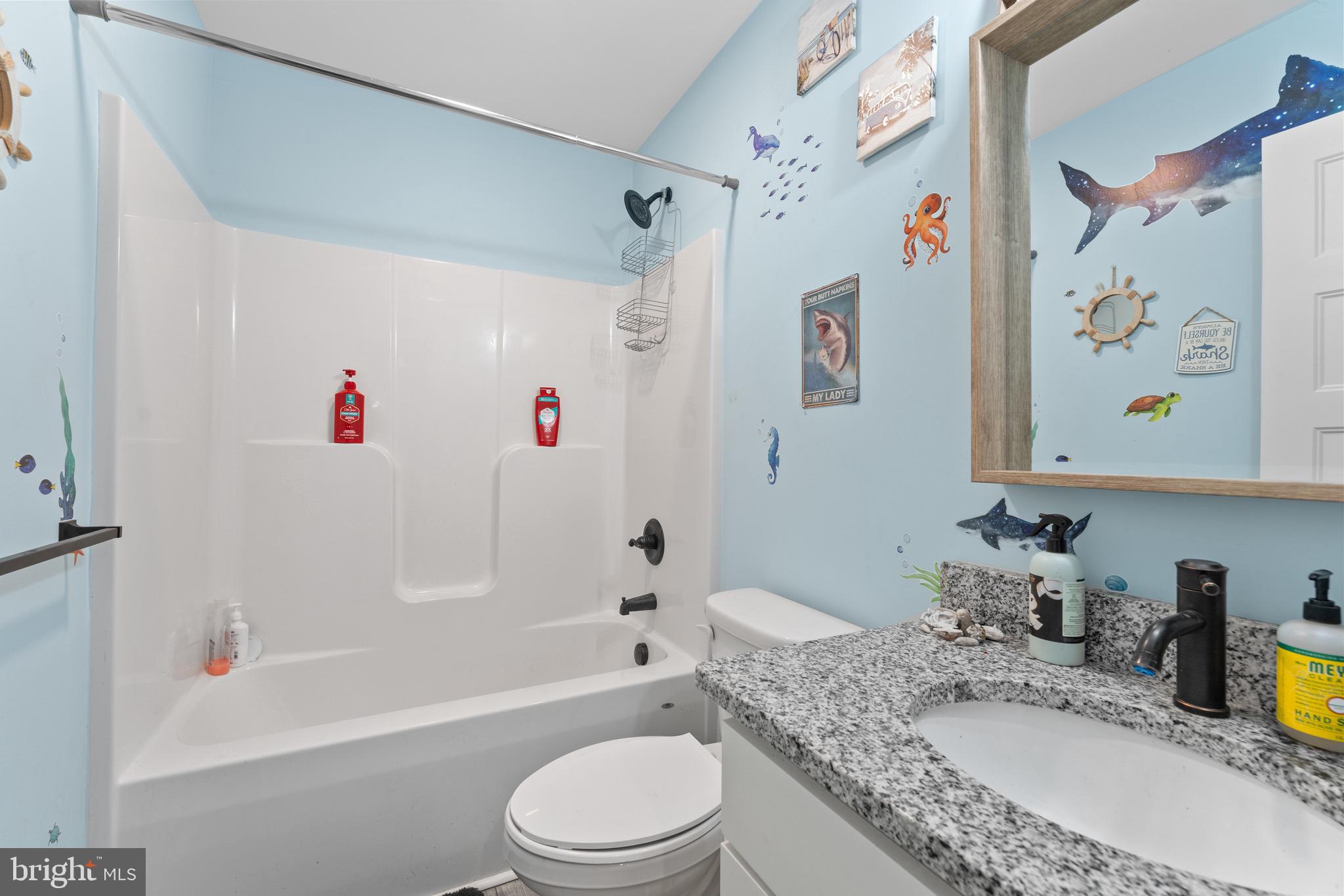 1322 Kennon Road Mineral, VA 23117 - Photo 17 of 27 a bathroom with a granite countertop sink a toilet and a bathtub