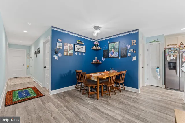 a view of a dining room with furniture and wooden floor