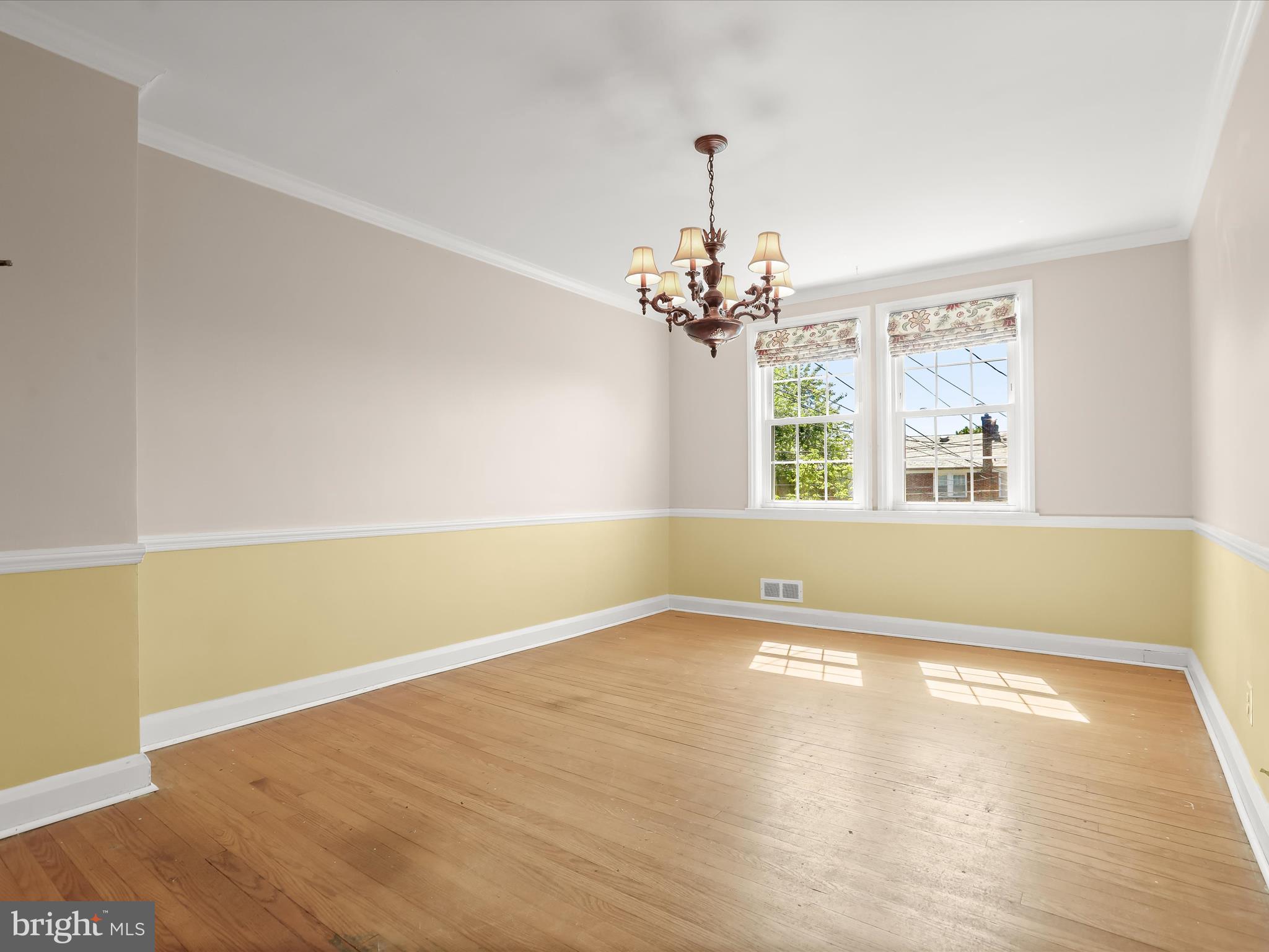415 Whitfield Road Catonsville, MD 21228 - Photo 11 of 43 a view of an empty room with a window and wooden floor