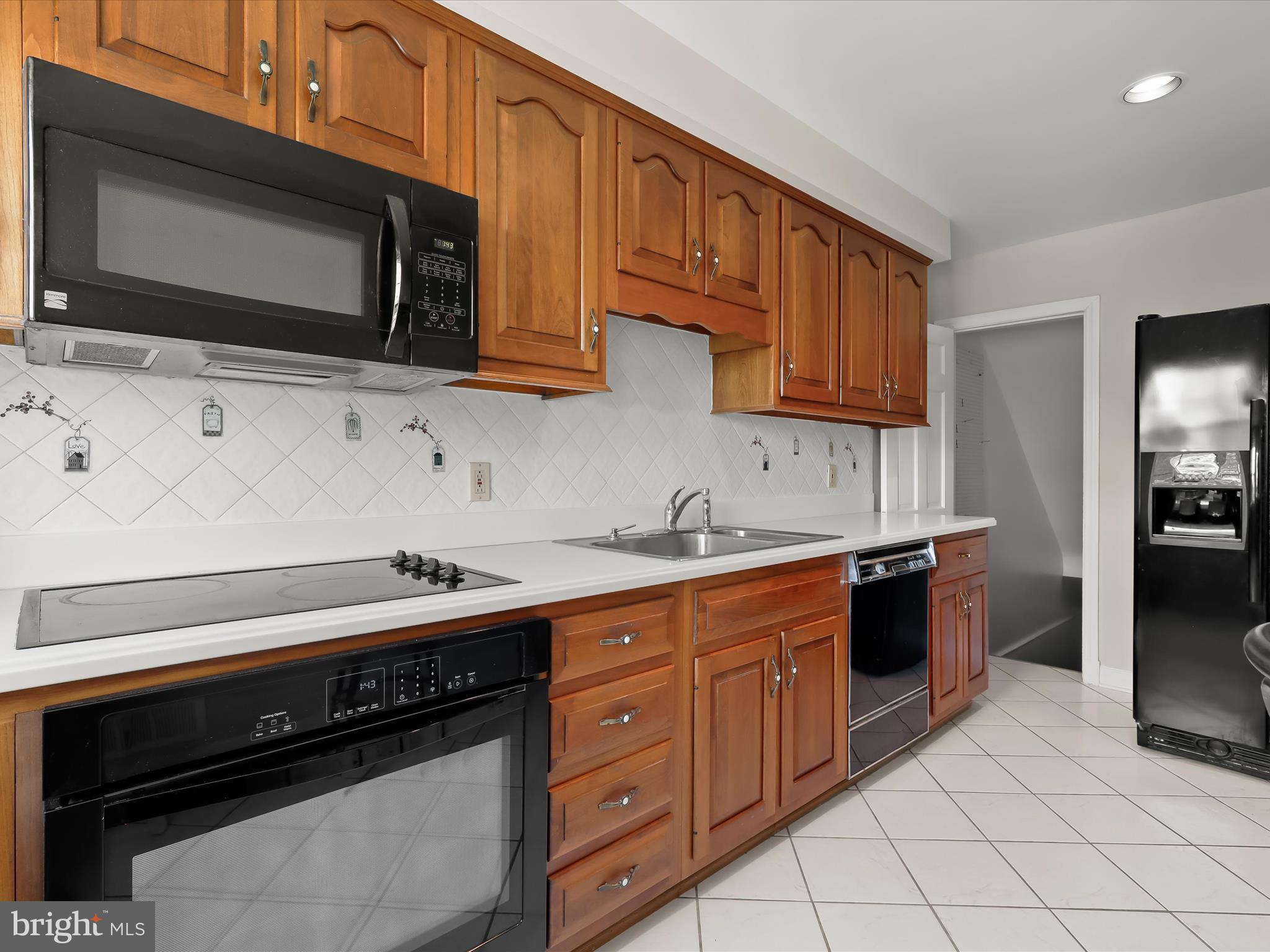 415 Whitfield Road Catonsville, MD 21228 - Photo 15 of 43 a kitchen with stainless steel appliances a stove microwave and cabinets