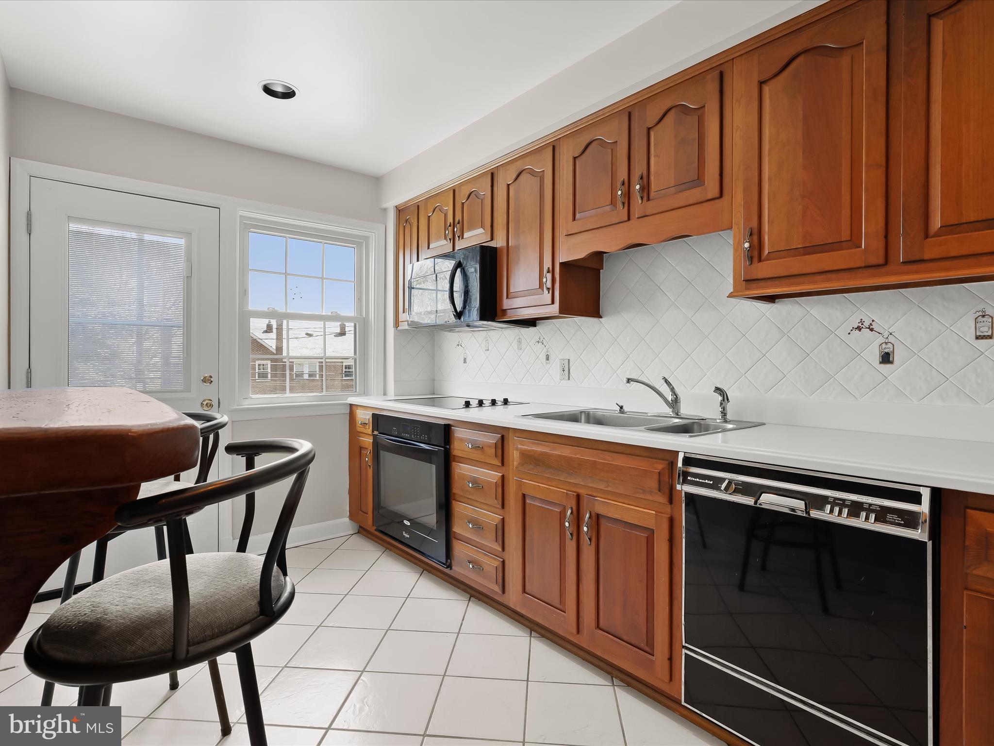 415 Whitfield Road Catonsville, MD 21228 - Photo 16 of 43 a kitchen with stainless steel appliances granite countertop a stove a sink dishwasher and a microwave oven with wooden cabinets
