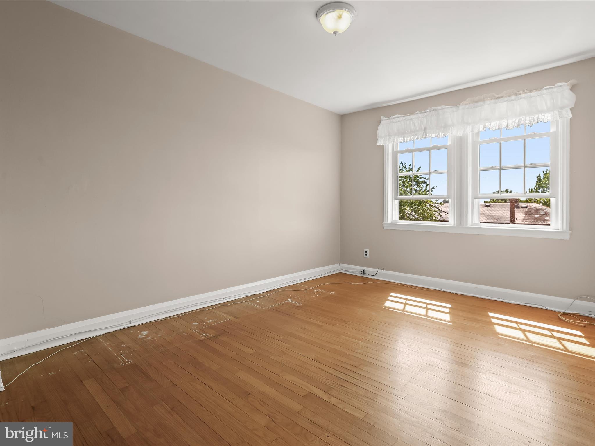 415 Whitfield Road Catonsville, MD 21228 - Photo 23 of 43 an empty room with wooden floor and windows
