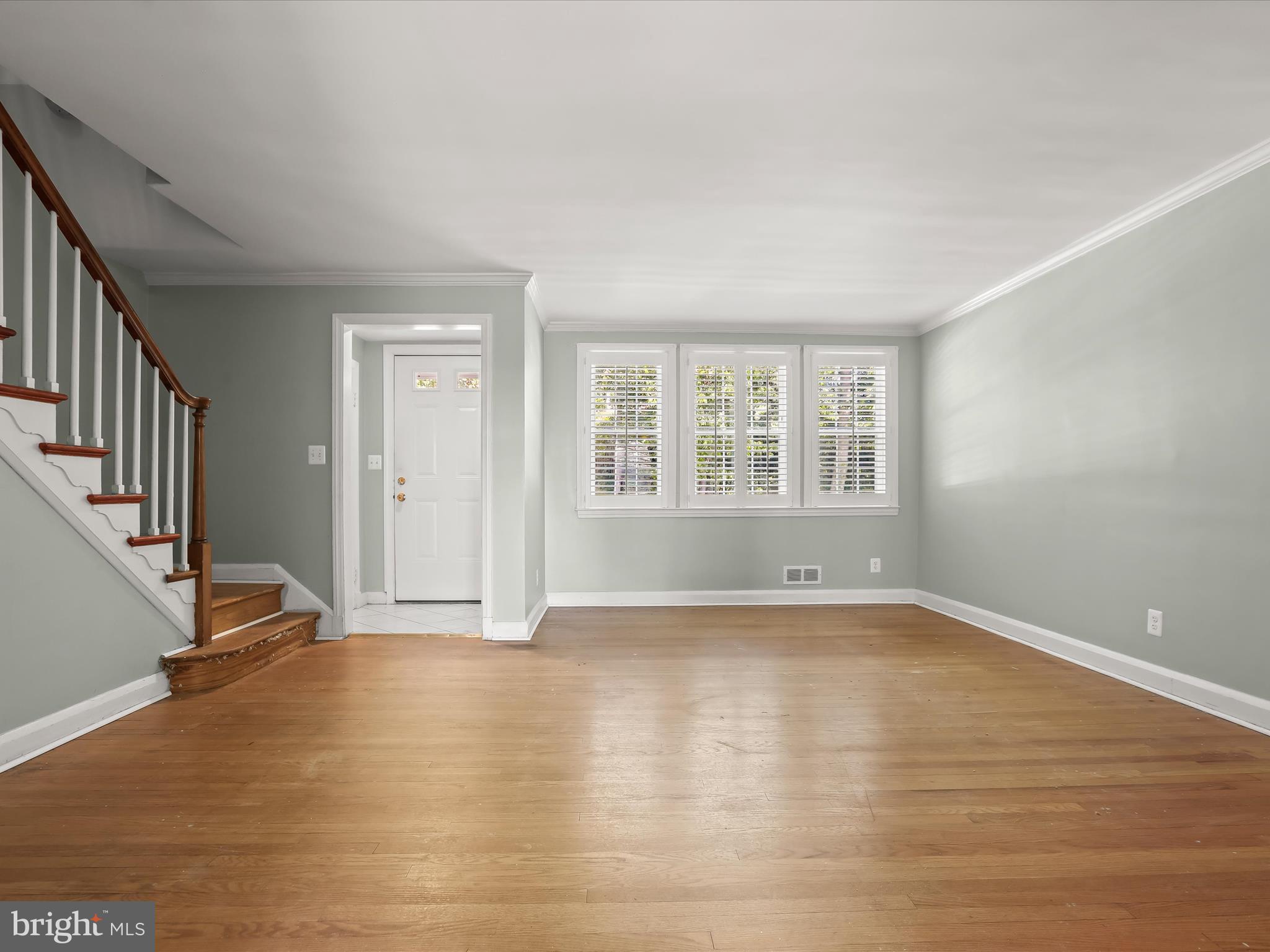 415 Whitfield Road Catonsville, MD 21228 - Photo 7 of 43 a view of an empty room with wooden floor and a window
