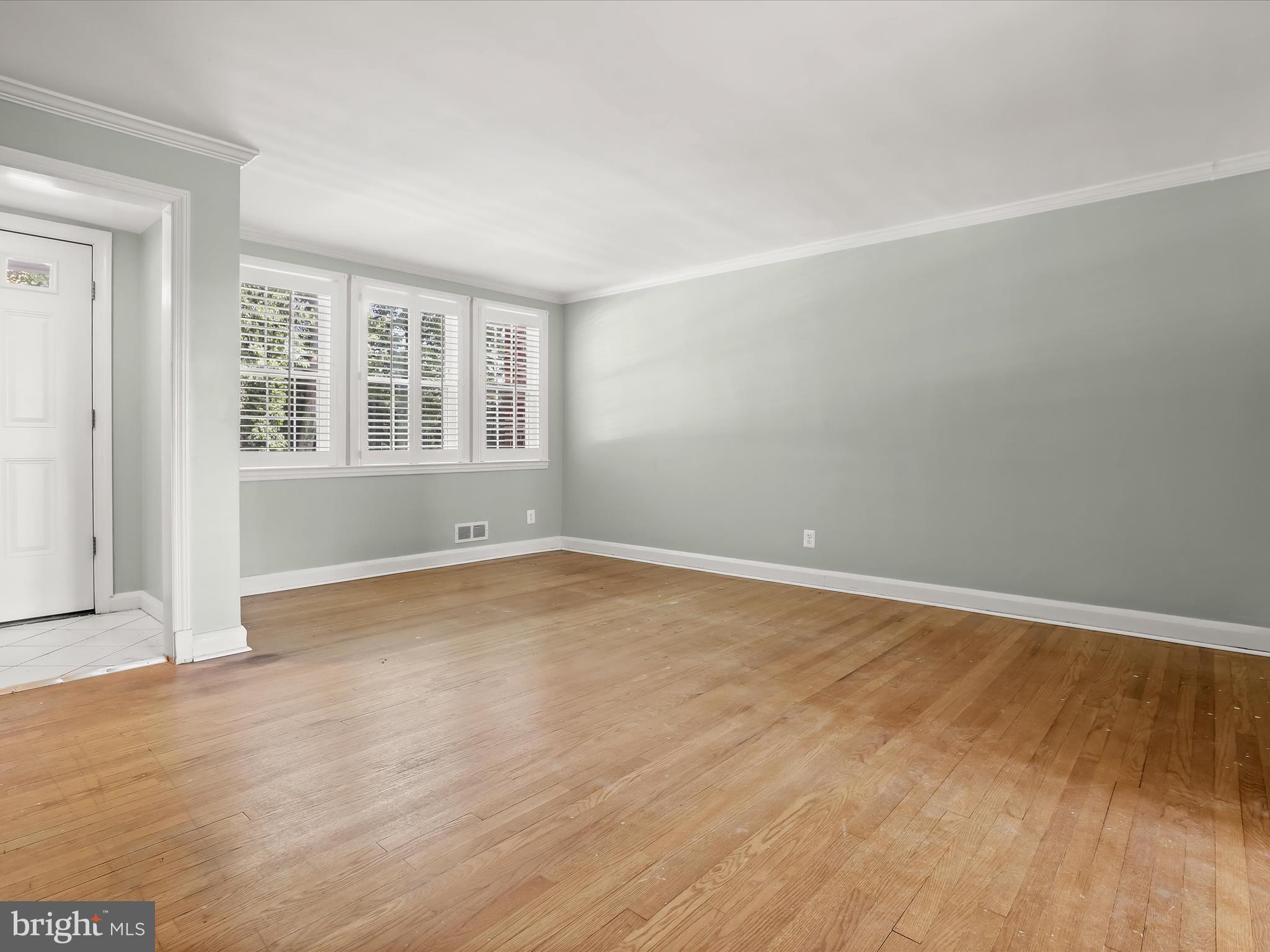 415 Whitfield Road Catonsville, MD 21228 - Photo 8 of 43 an empty room with wooden floor and windows
