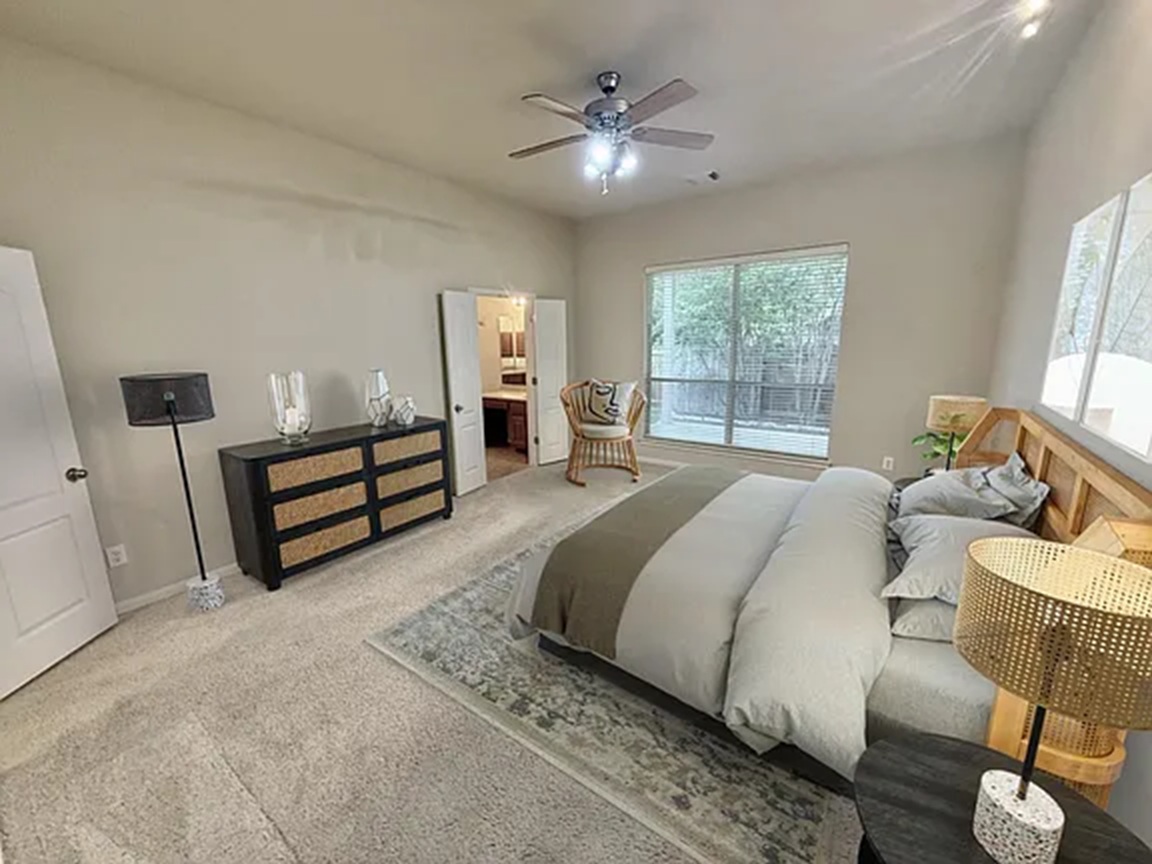 608 Pebblestone Walk Drive Cedar Park, TX 78613 - Photo 16 of 27 Carpeted bedroom featuring ensuite bathroom and a ceiling fan