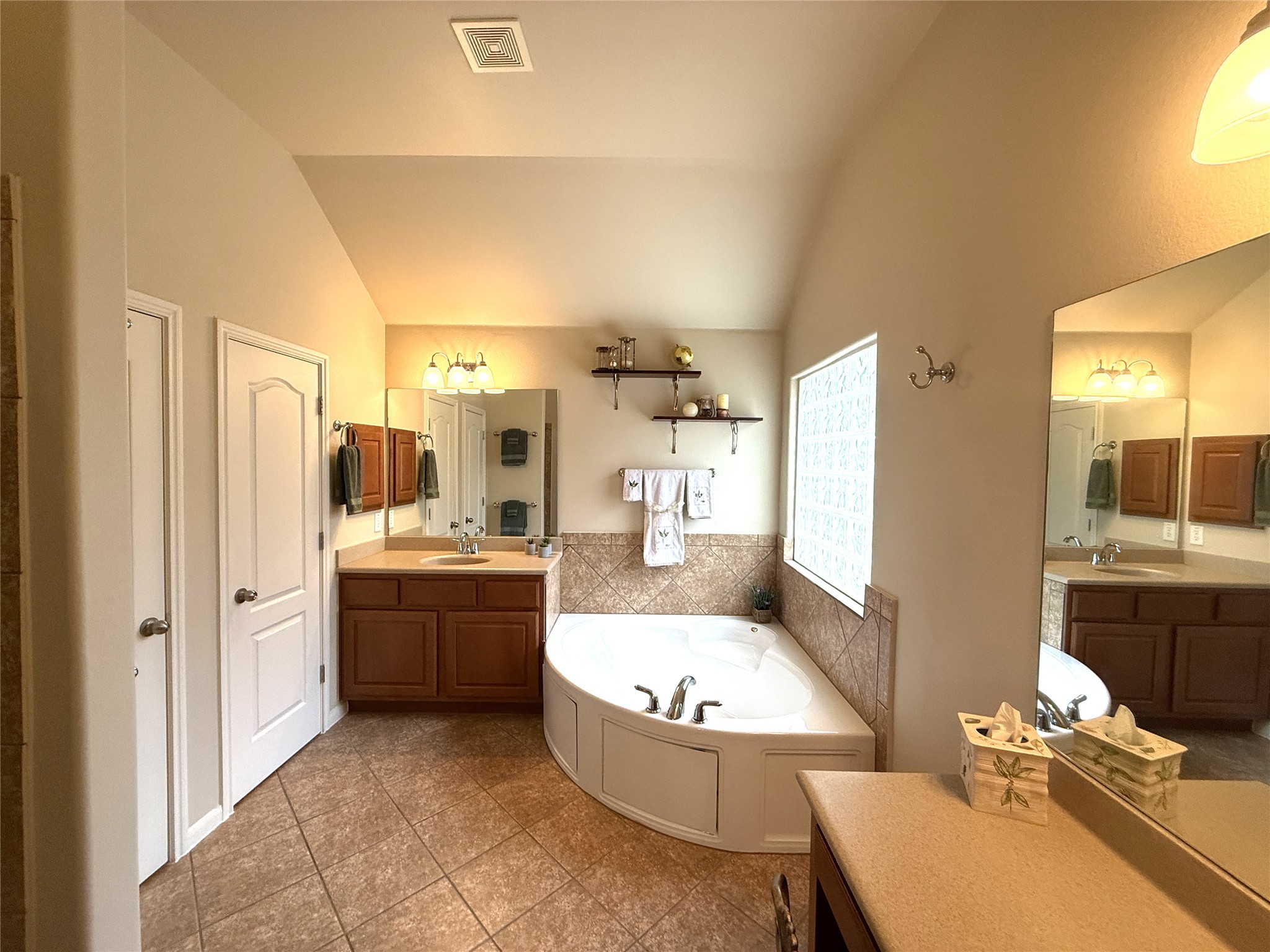 608 Pebblestone Walk Drive Cedar Park, TX 78613 - Photo 18 of 27 Bathroom with two vanities, a bath, and lofted ceiling