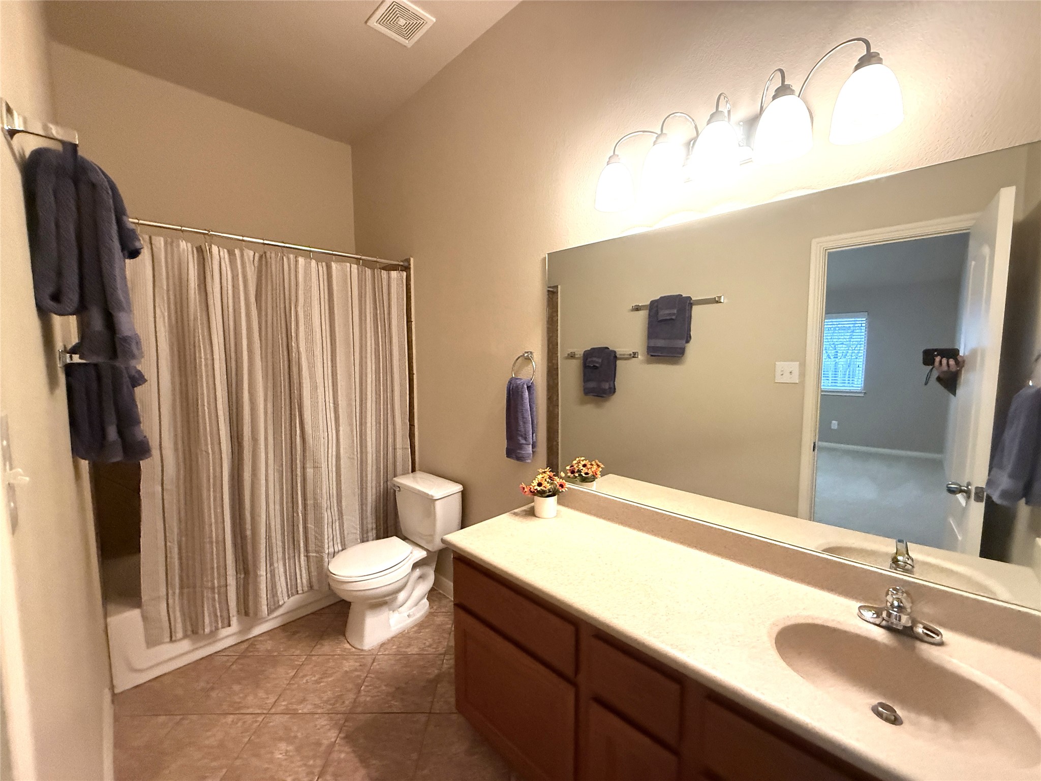 608 Pebblestone Walk Drive Cedar Park, TX 78613 - Photo 20 of 27 Full bathroom with vanity, shower / bathtub combination with curtain, and light tile patterned floors