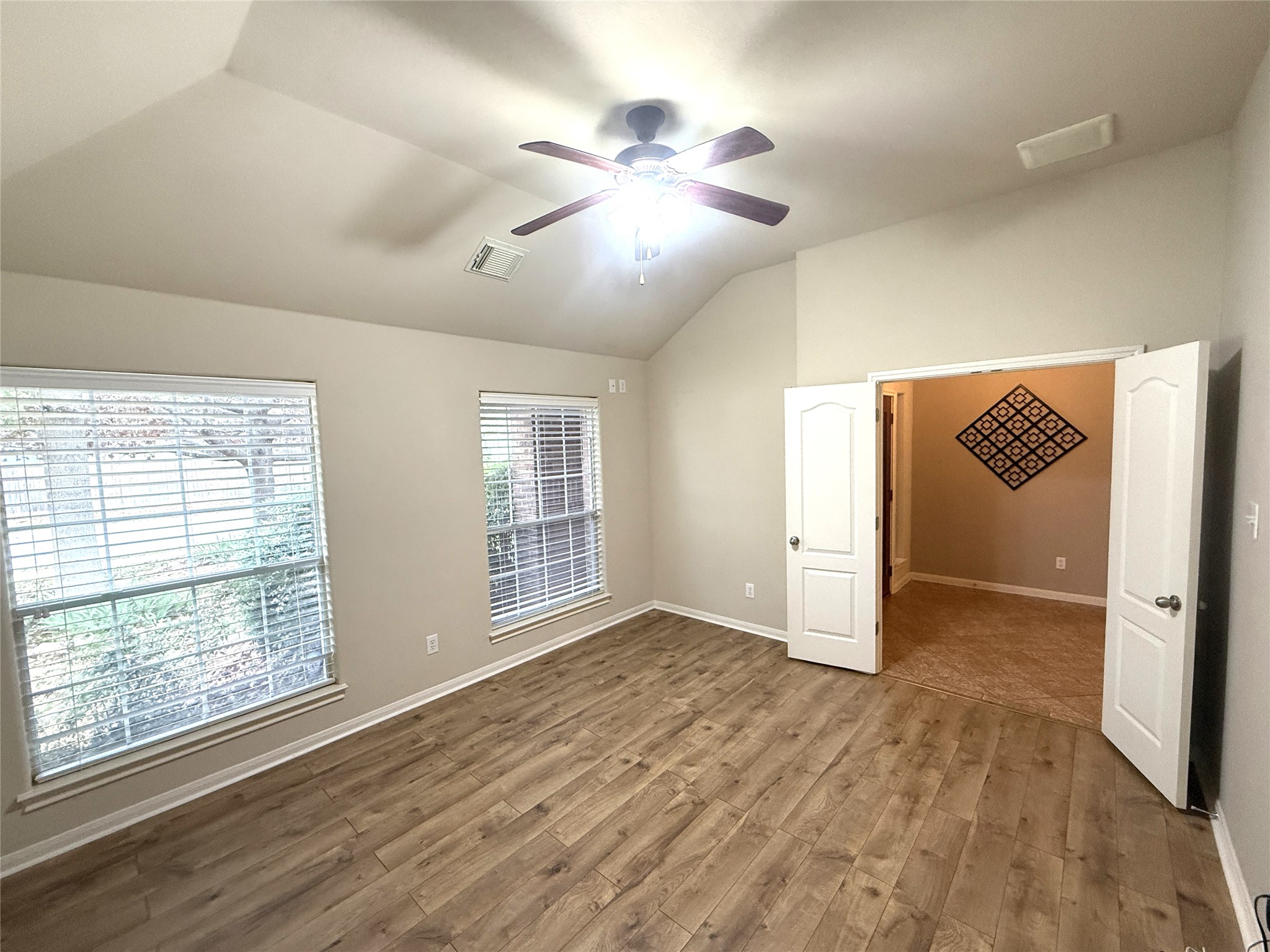 608 Pebblestone Walk Drive Cedar Park, TX 78613 - Photo 5 of 27 Empty room featuring vaulted ceiling, a ceiling fan, and light wood-style floors