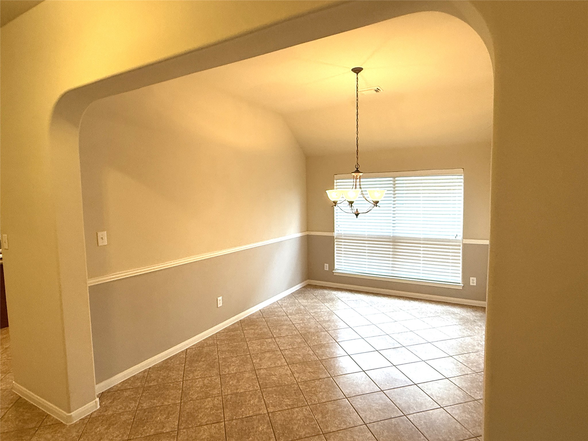 608 Pebblestone Walk Drive Cedar Park, TX 78613 - Photo 6 of 27 Spare room with arched walkways, vaulted ceiling, and light tile patterned floors