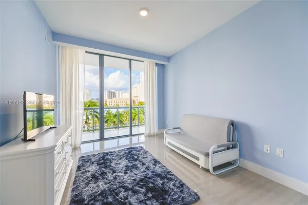 a living room with a large window with a flat screen tv