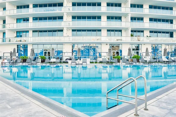 a view of a swimming pool with outdoor seating