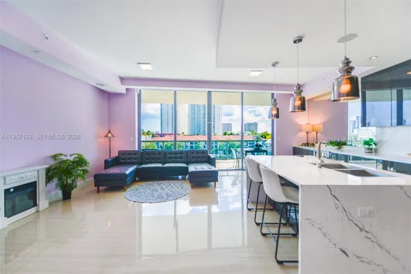 a kitchen with granite countertop a table and chairs in it