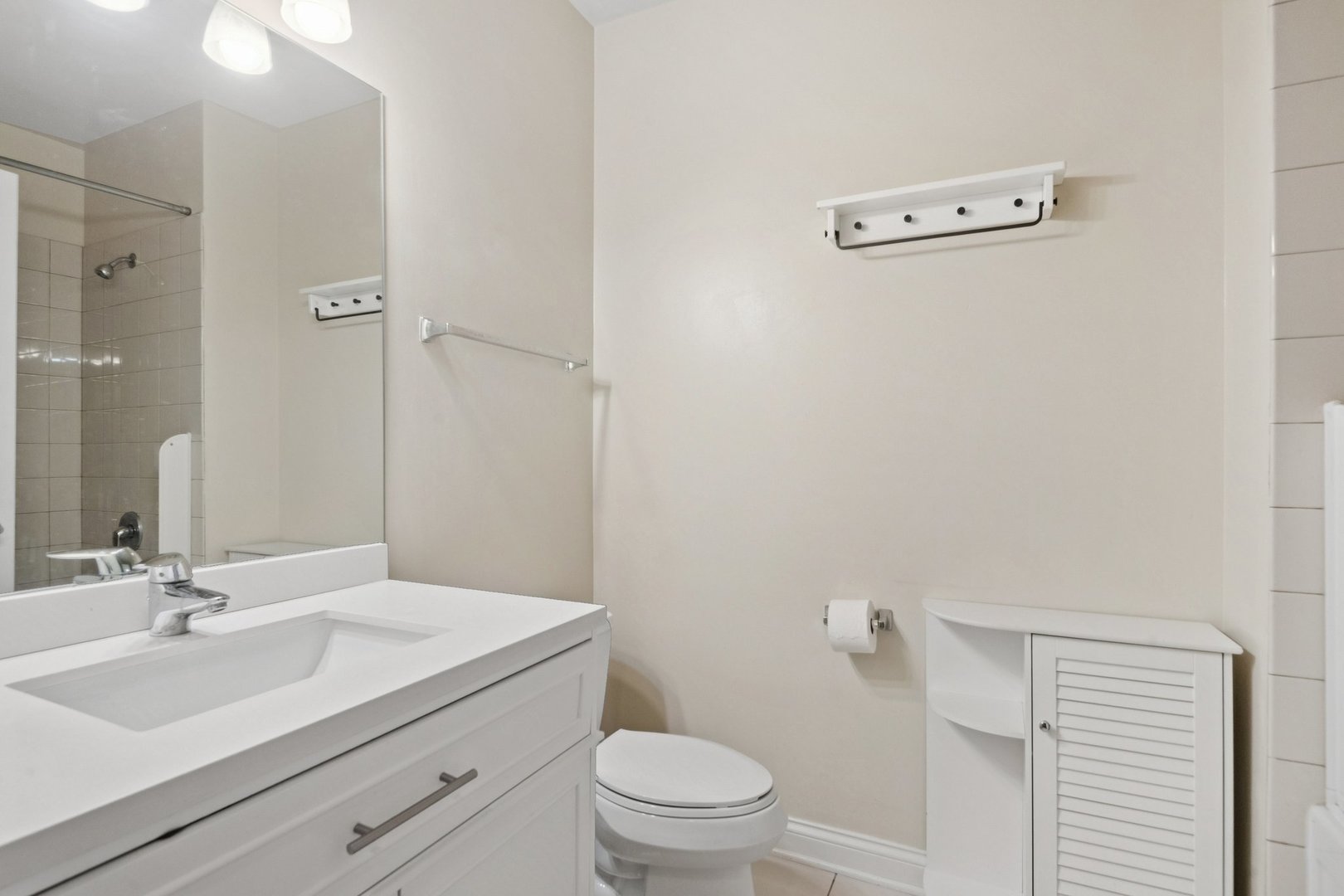8 West Monroe Street, Unit 1209 Chicago, IL 60603 - Photo 15 of 24 a bathroom with a sink a toilet and a mirror