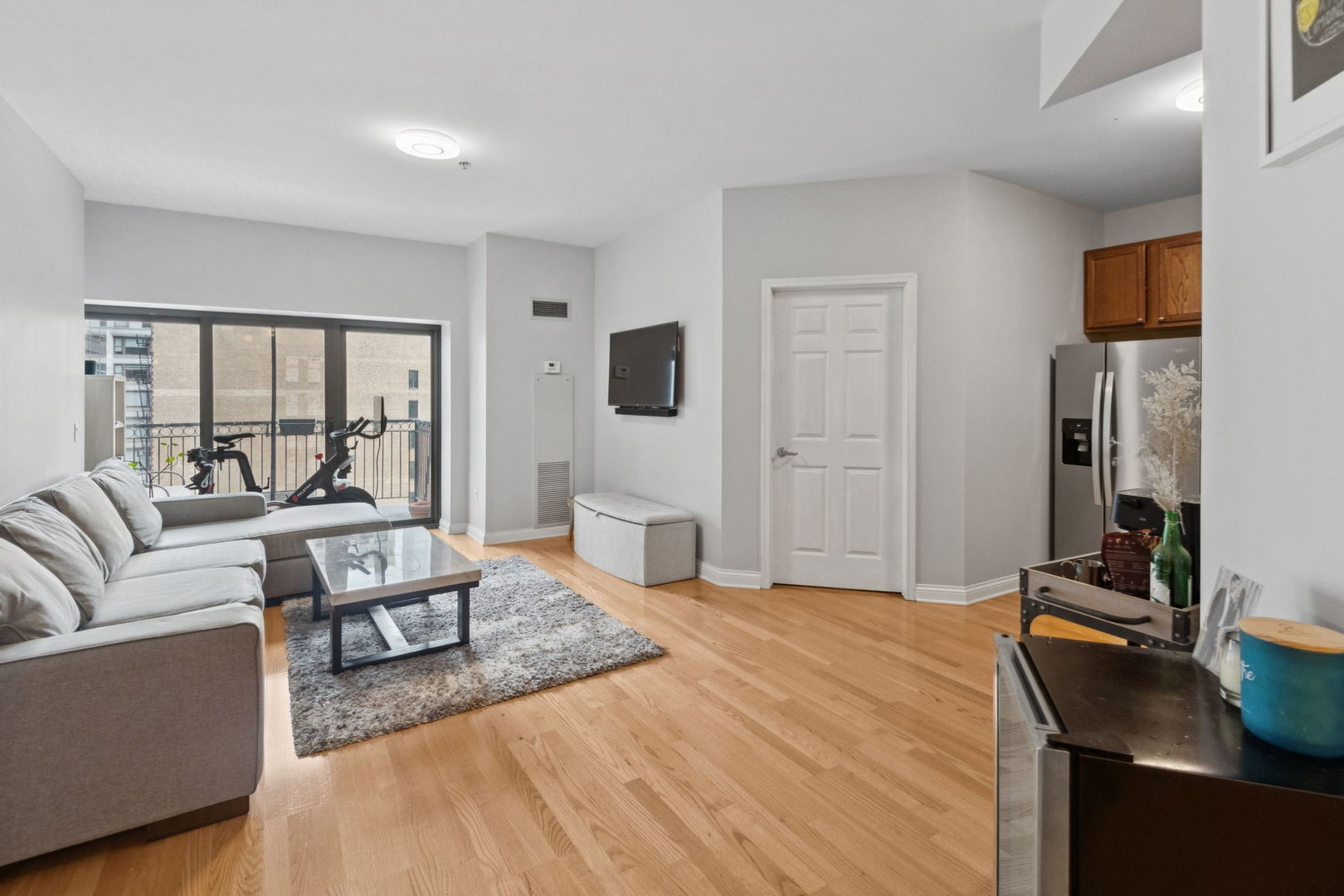 8 West Monroe Street, Unit 1209 Chicago, IL 60603 - Photo 3 of 24 a living room with furniture and a flat screen tv