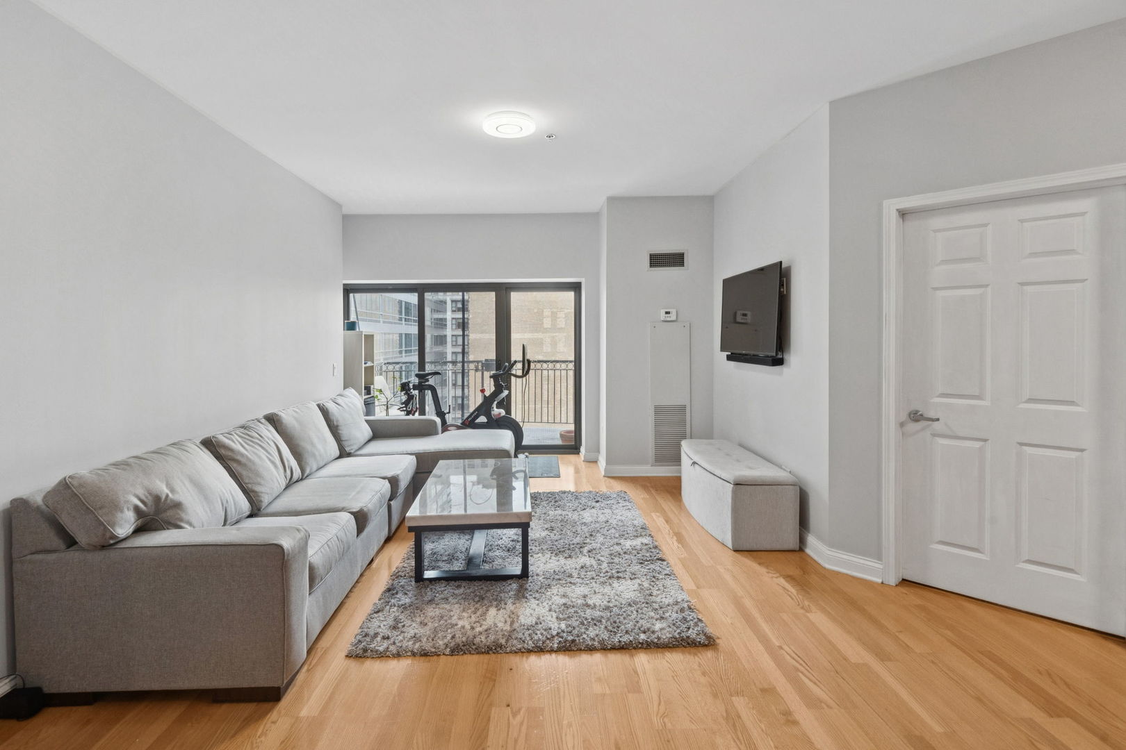 8 West Monroe Street, Unit 1209 Chicago, IL 60603 - Photo 4 of 24 a living room with furniture and a flat screen tv