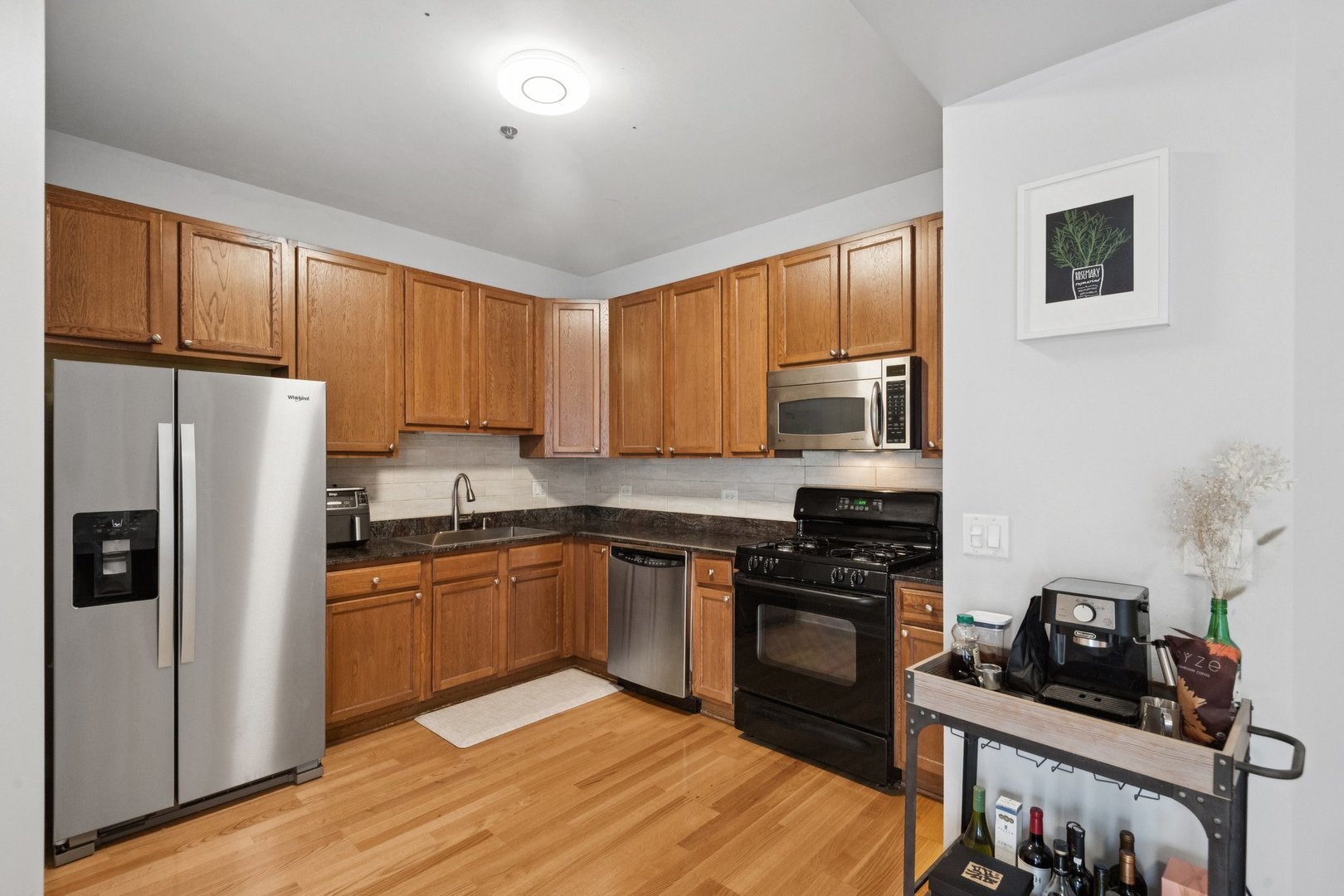 8 West Monroe Street, Unit 1209 Chicago, IL 60603 - Photo 7 of 24 a kitchen with stainless steel appliances granite countertop a refrigerator stove top oven a sink and dishwasher