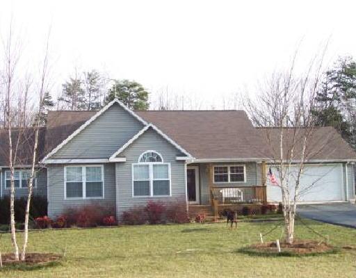 895 Hatchett Road Penhook, VA 24137 - Photo 1 of 1 a front view of house with yard and trees in the background