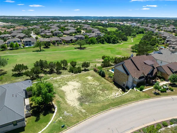 an aerial view of a houses with a yard