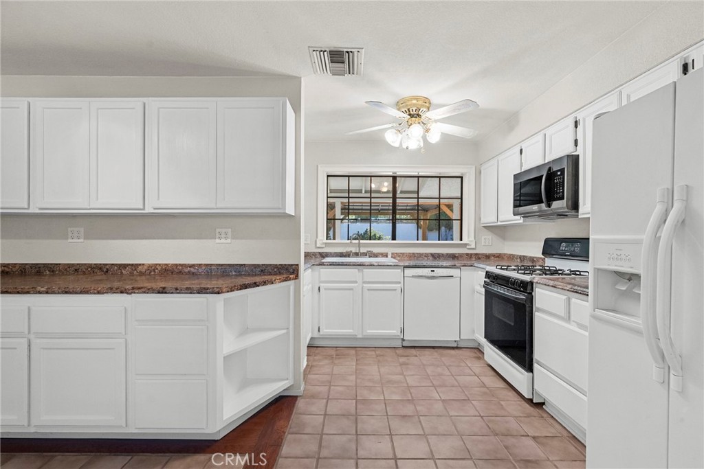 4790 Adam Road Simi Valley, CA 93063 - Photo 14 of 61 a kitchen with stainless steel appliances granite countertop a stove a sink and a refrigerator