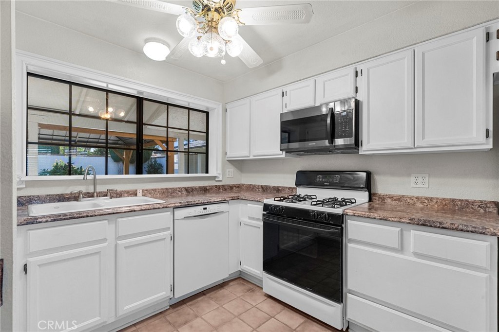 4790 Adam Road Simi Valley, CA 93063 - Photo 16 of 61 a kitchen with a stove and a sink