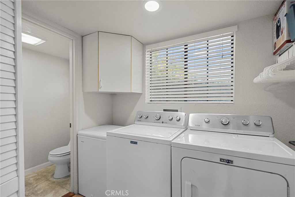 4790 Adam Road Simi Valley, CA 93063 - Photo 23 of 61 a view of washer and dryer with bathroom in the background