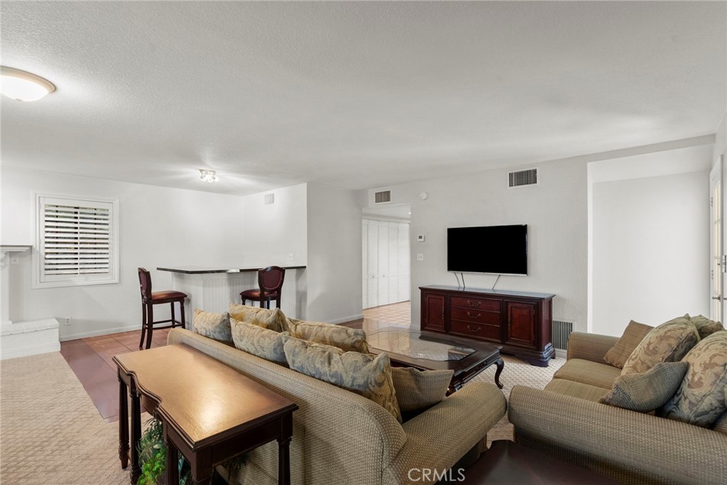 4790 Adam Road Simi Valley, CA 93063 - Photo 32 of 61 a living room with furniture and a flat screen tv
