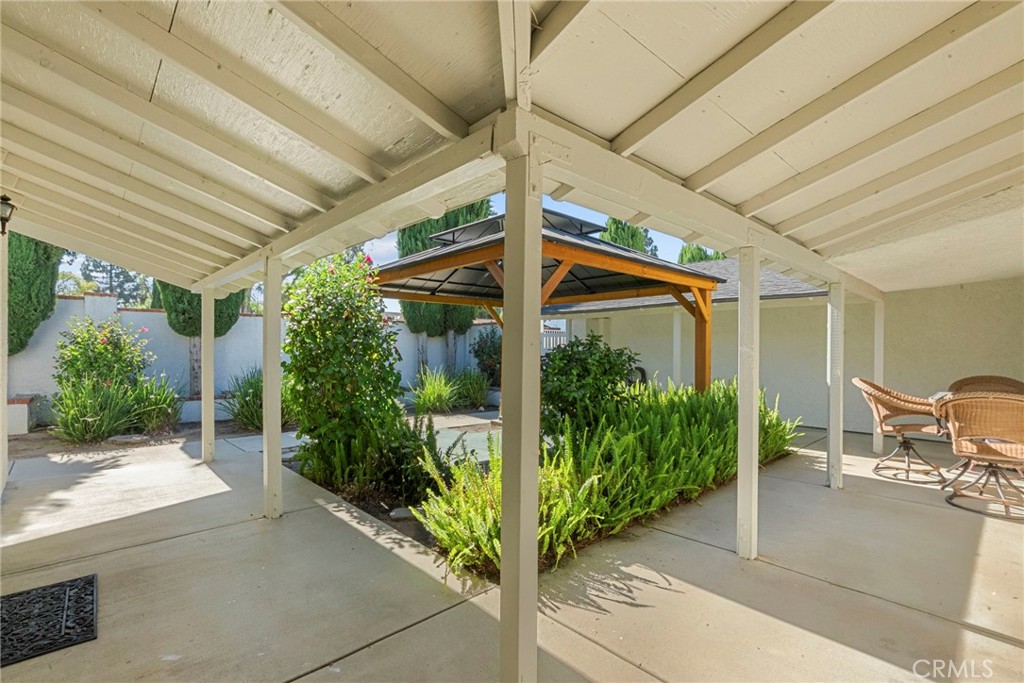 4790 Adam Road Simi Valley, CA 93063 - Photo 40 of 61 a view of a patio with table and chairs potted plants