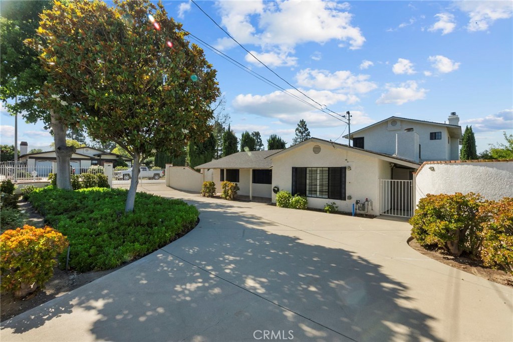 4790 Adam Road Simi Valley, CA 93063 - Photo 61 of 61 a front view of a house with a garden and trees