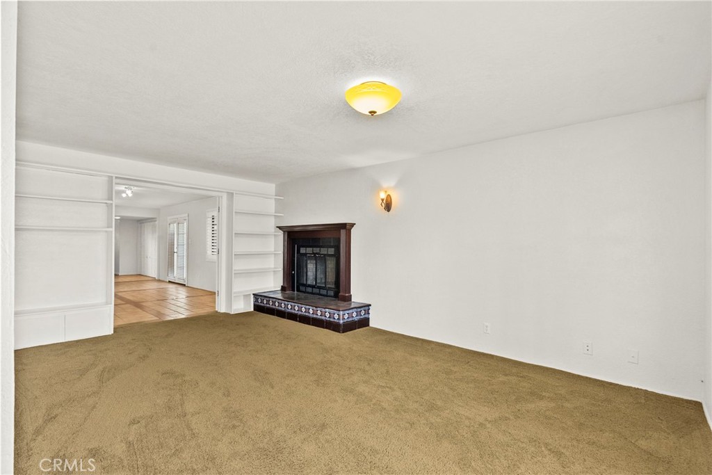 4790 Adam Road Simi Valley, CA 93063 - Photo 8 of 61 a view of empty room with wooden floor and fireplace