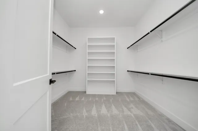 an empty room with a ceiling fan and window