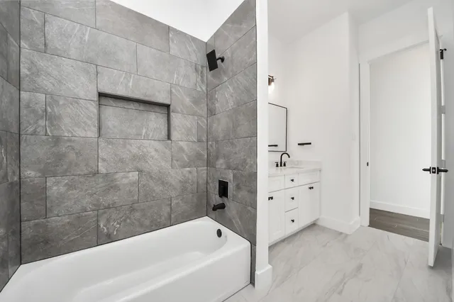 a view of a house with a yard and potted plants