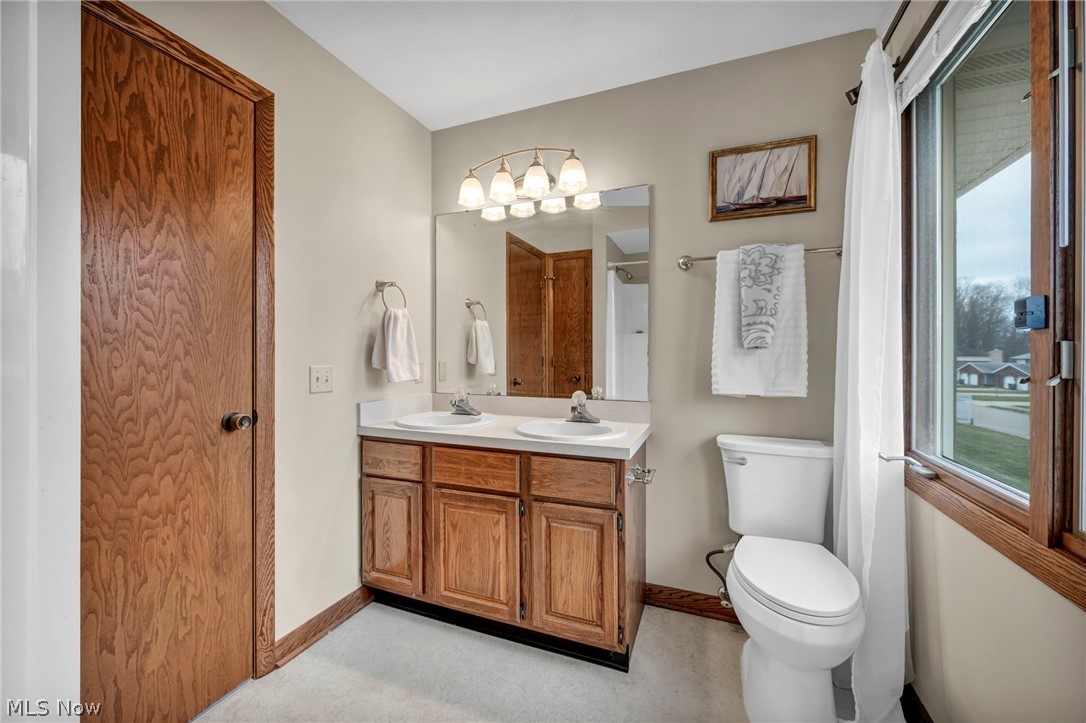 5162 Johnnycake Ridge Northeast Canton, OH 44705 - Photo 33 of 50 Bathroom with double vanity and curtained shower