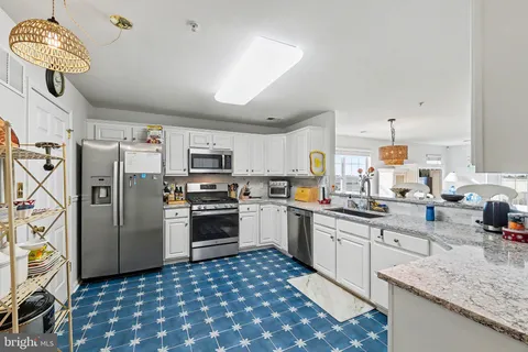 a living room with furniture a rug and a flat screen tv