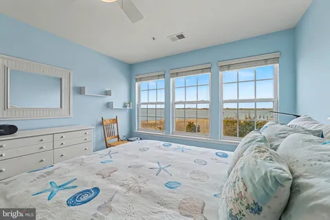 a bathroom with a granite countertop sink a toilet and a mirror