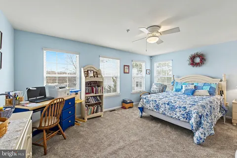 a bedroom with a bed and a dresser with mirror