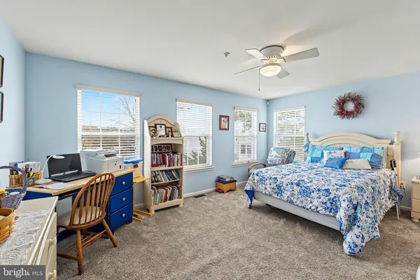 a bedroom with a bed and a dresser with mirror