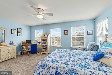 a bathroom with a granite countertop sink a toilet and a shower curtain