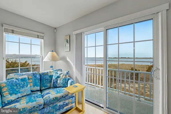 a living room with furniture fireplace and a window