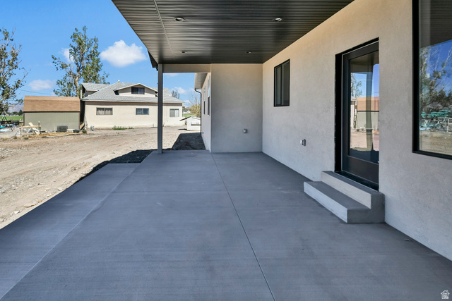 840 South Jones Road Monroe, UT 84754 - Photo 36 of 52 Covered concrete patio with recessed lighting, stucco exterior, and black-framed windows