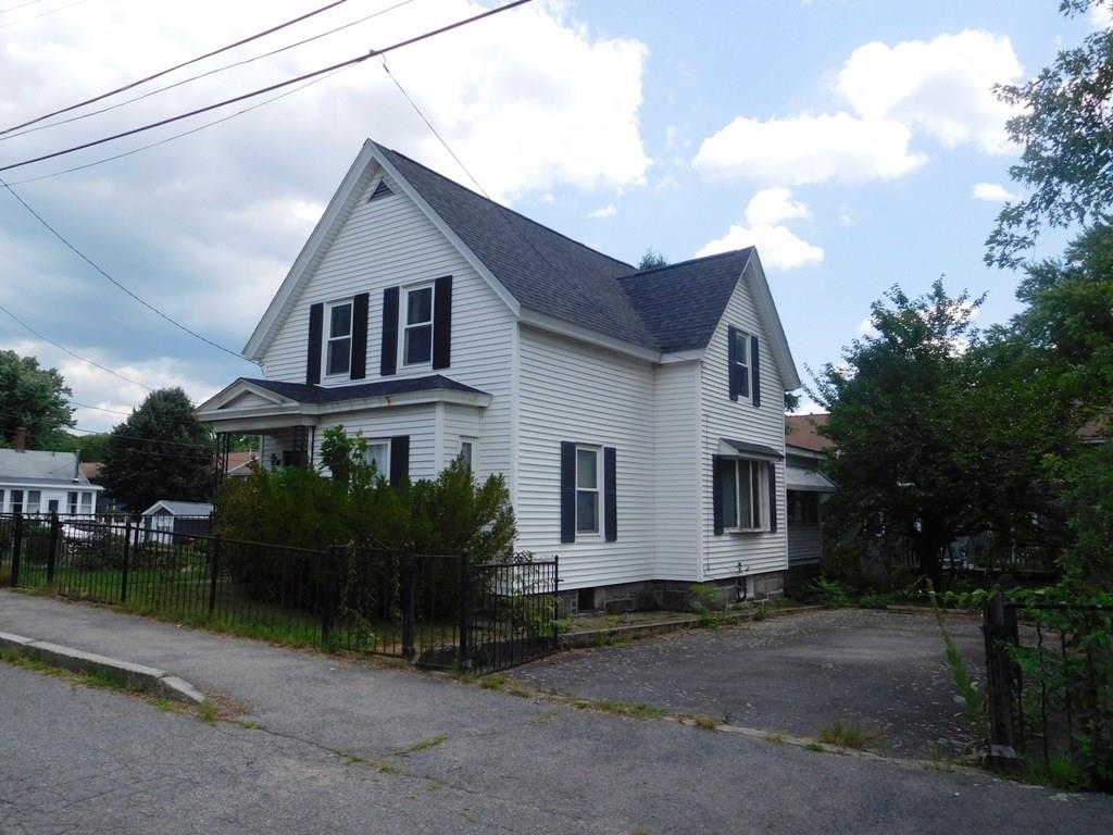 19 Juniper Street Lowell, MA 01852 - Photo 1 of 24 a front view of a house with garden