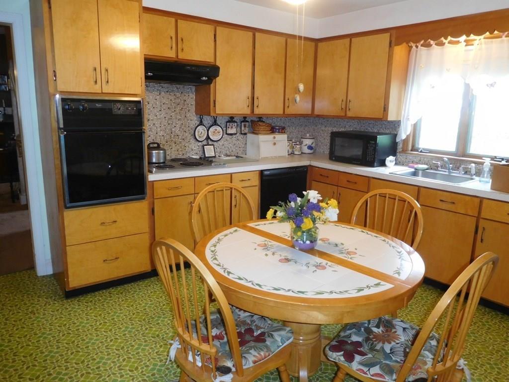 19 Juniper Street Lowell, MA 01852 - Photo 11 of 24 a kitchen with a appliances a sink and cabinets