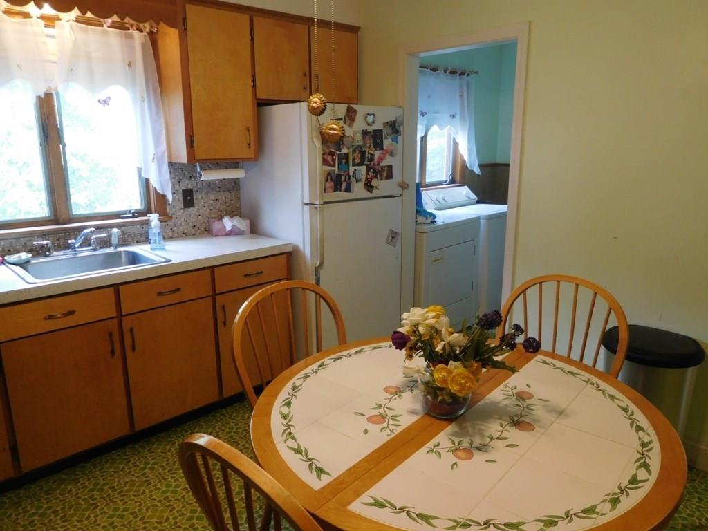 19 Juniper Street Lowell, MA 01852 - Photo 12 of 24 a kitchen with stainless steel appliances granite countertop a sink a refrigerator and a stove